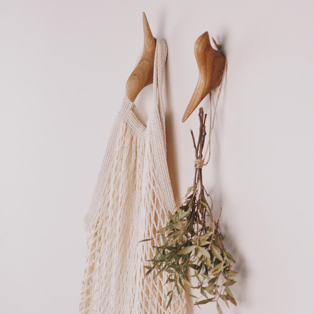 Minimalist solid oak hooks with a bird design