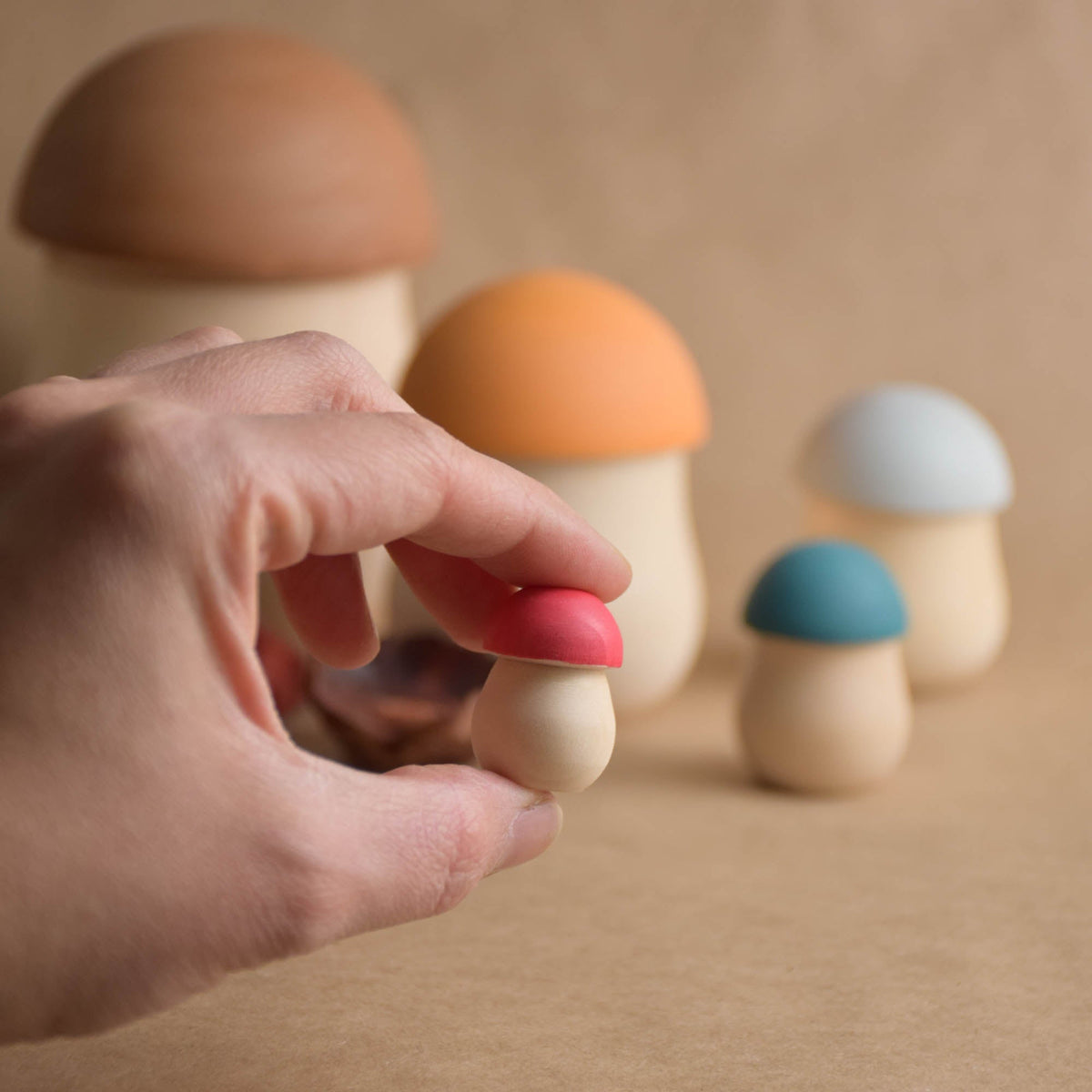 Colorful wooden mushrooms with a nesting design