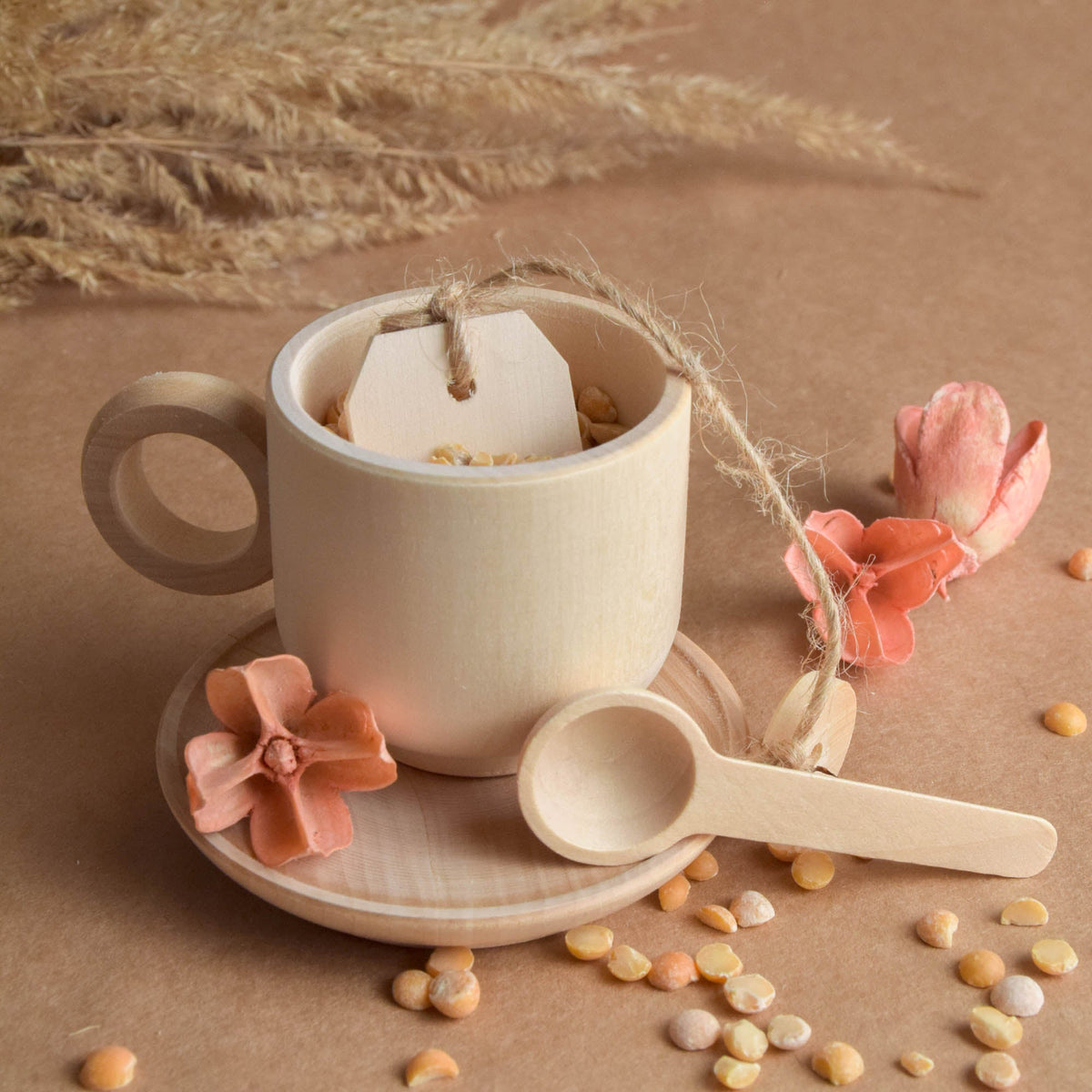 Handmade wooden pastel tea and cake play set for Montessori-inspired play with a natural colored wax finish