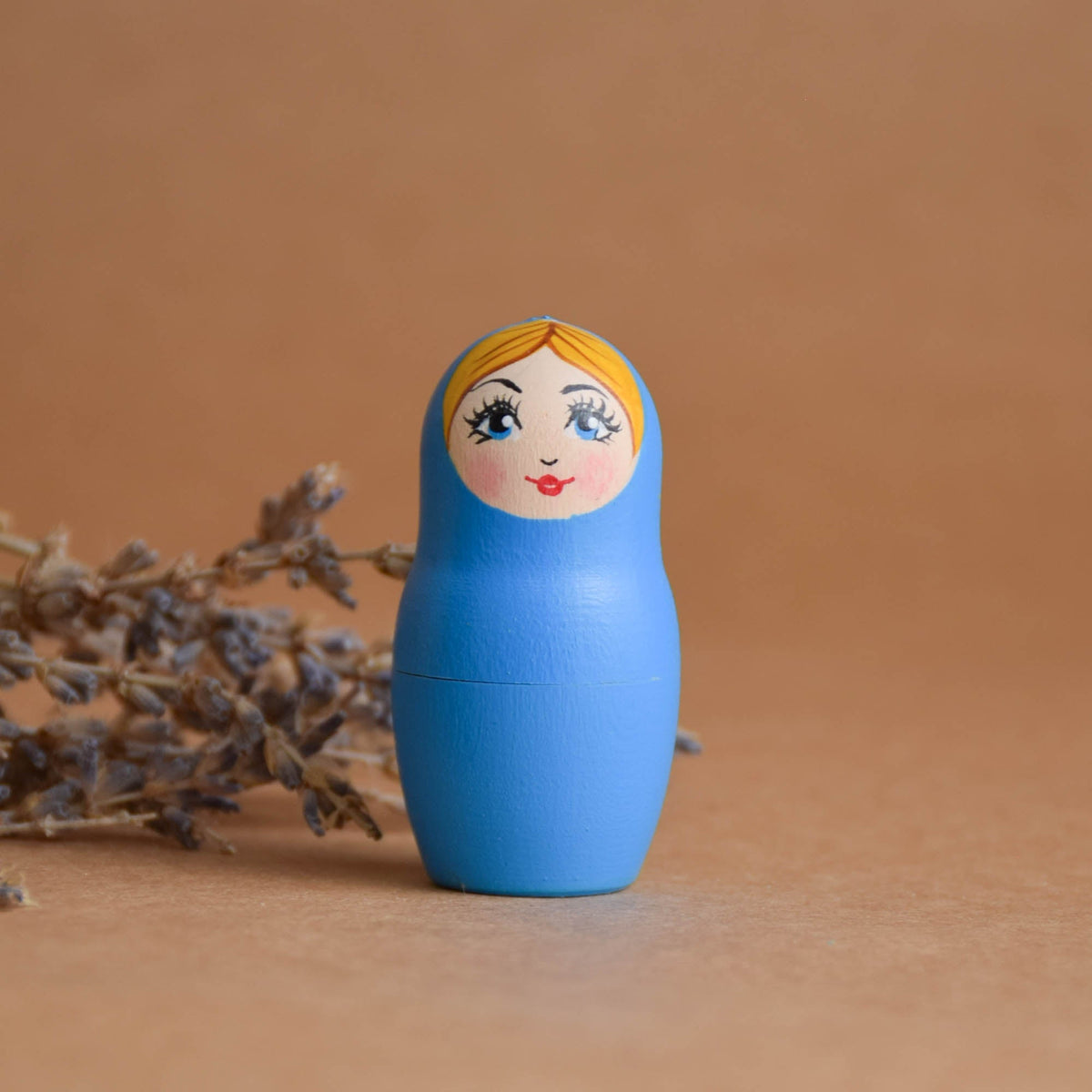 Hand-painted matryoshka nesting dolls in natural wood