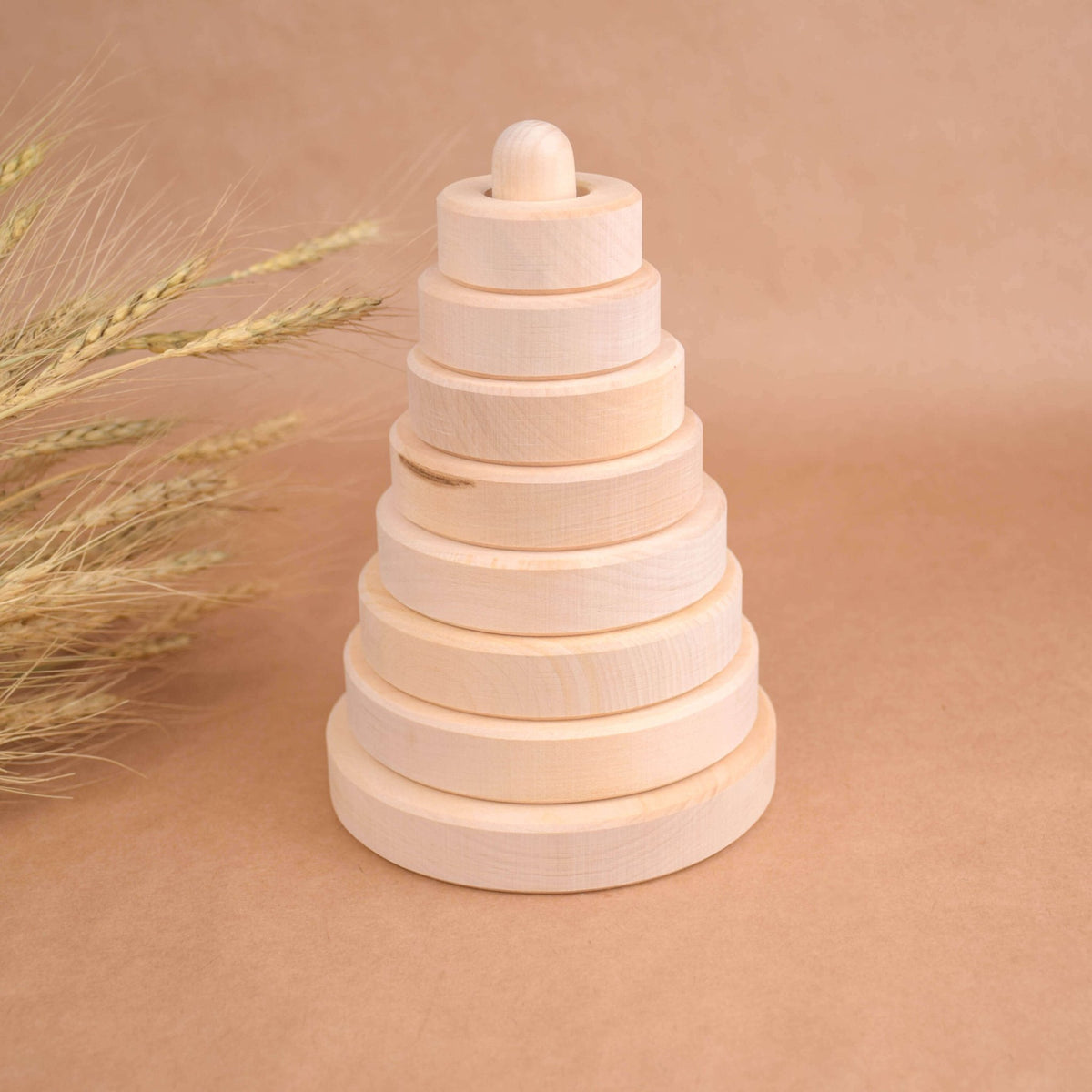 Ring stacking toy made from linden wood, with rings