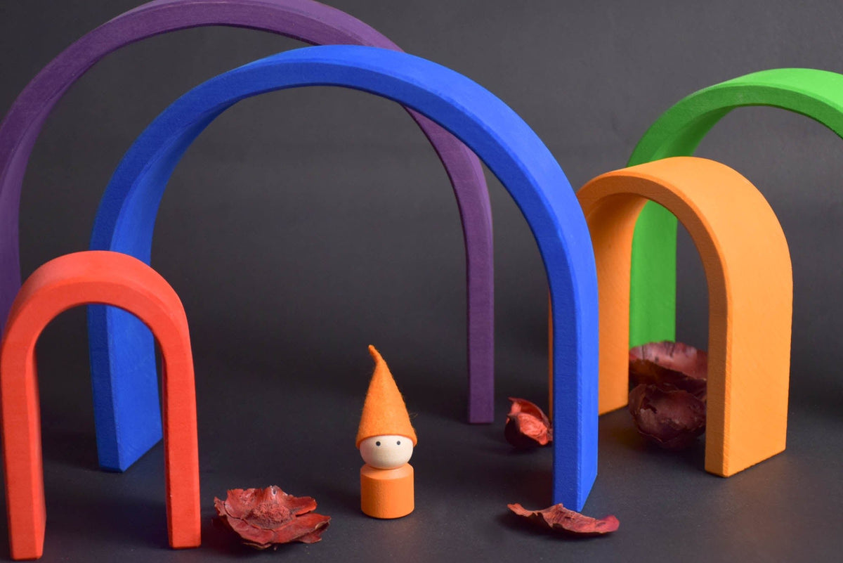 Handmade Montessori oval rainbow stacker in linden wood with a natural colored wax-and-oil finish
