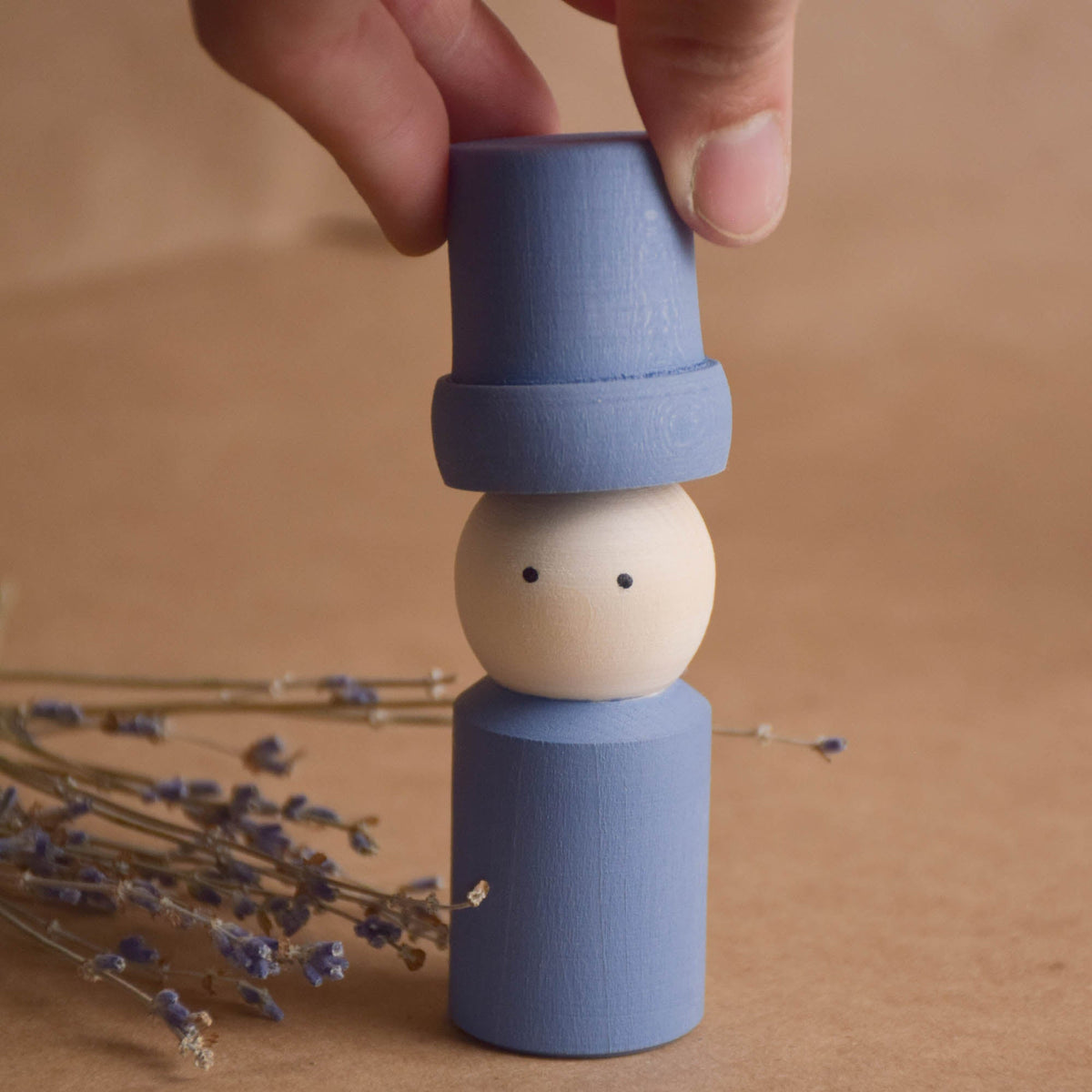 Pastel peg doll family with opening hats