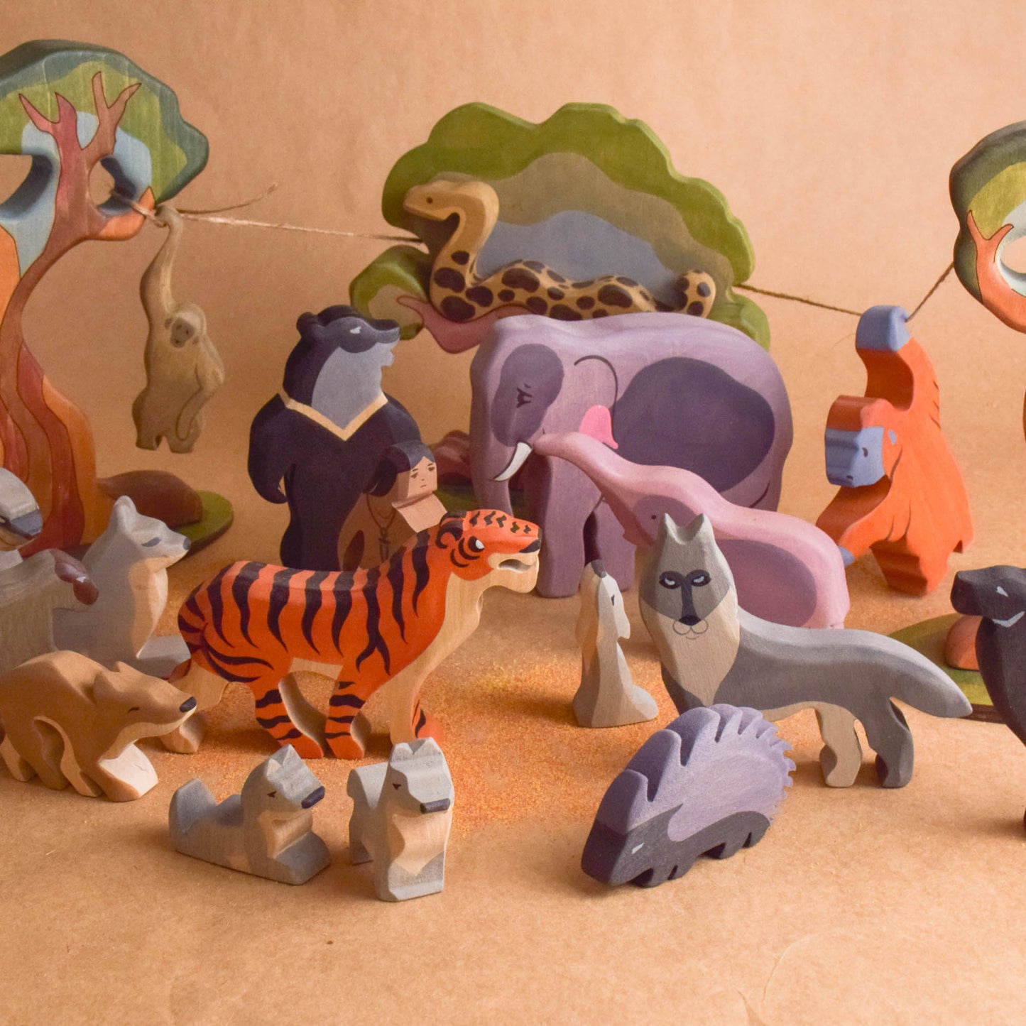 Collection of colorful wooden animal toys on a beige surface