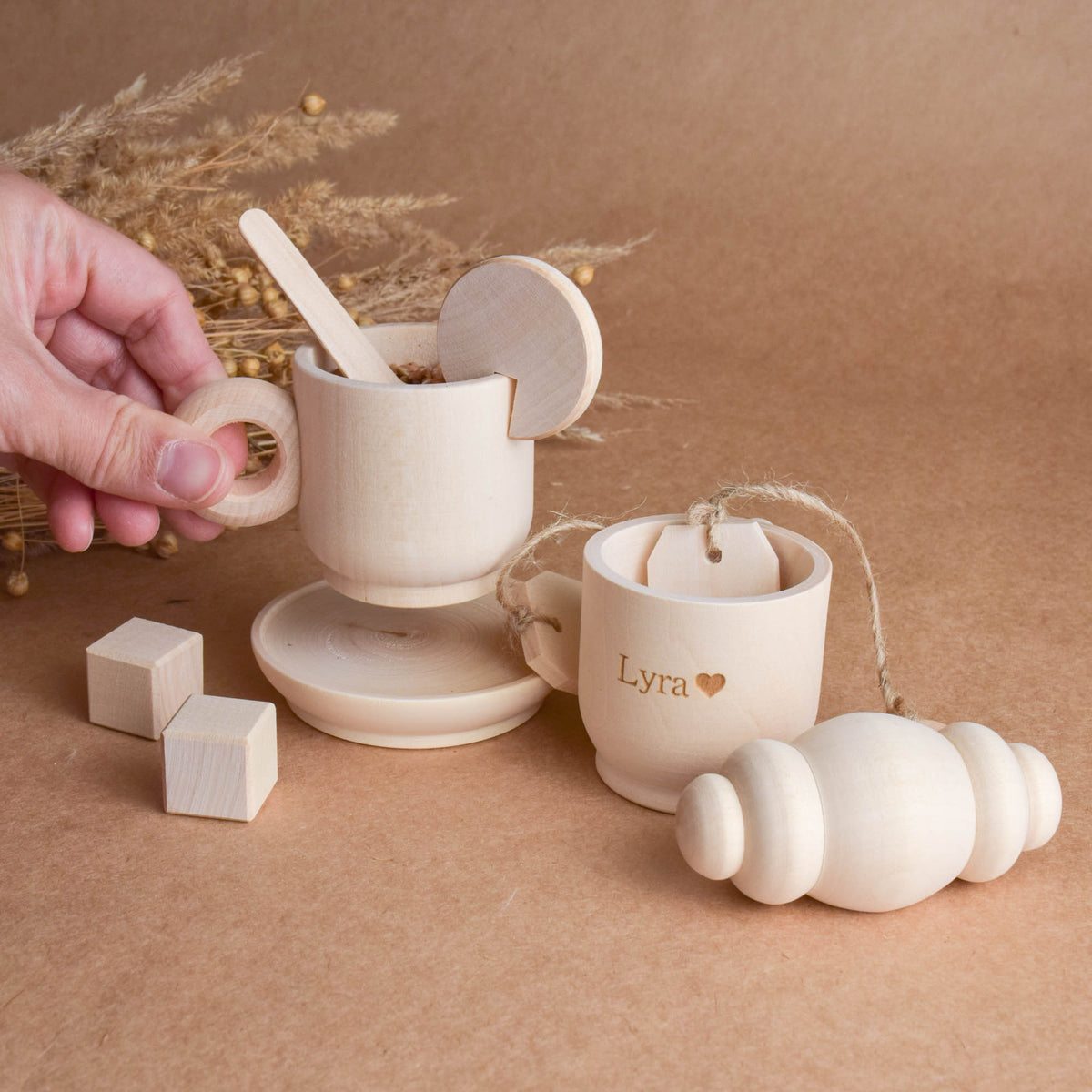 Handmade wooden tea party accessories for Montessori-inspired play, crafted from natural solid wood