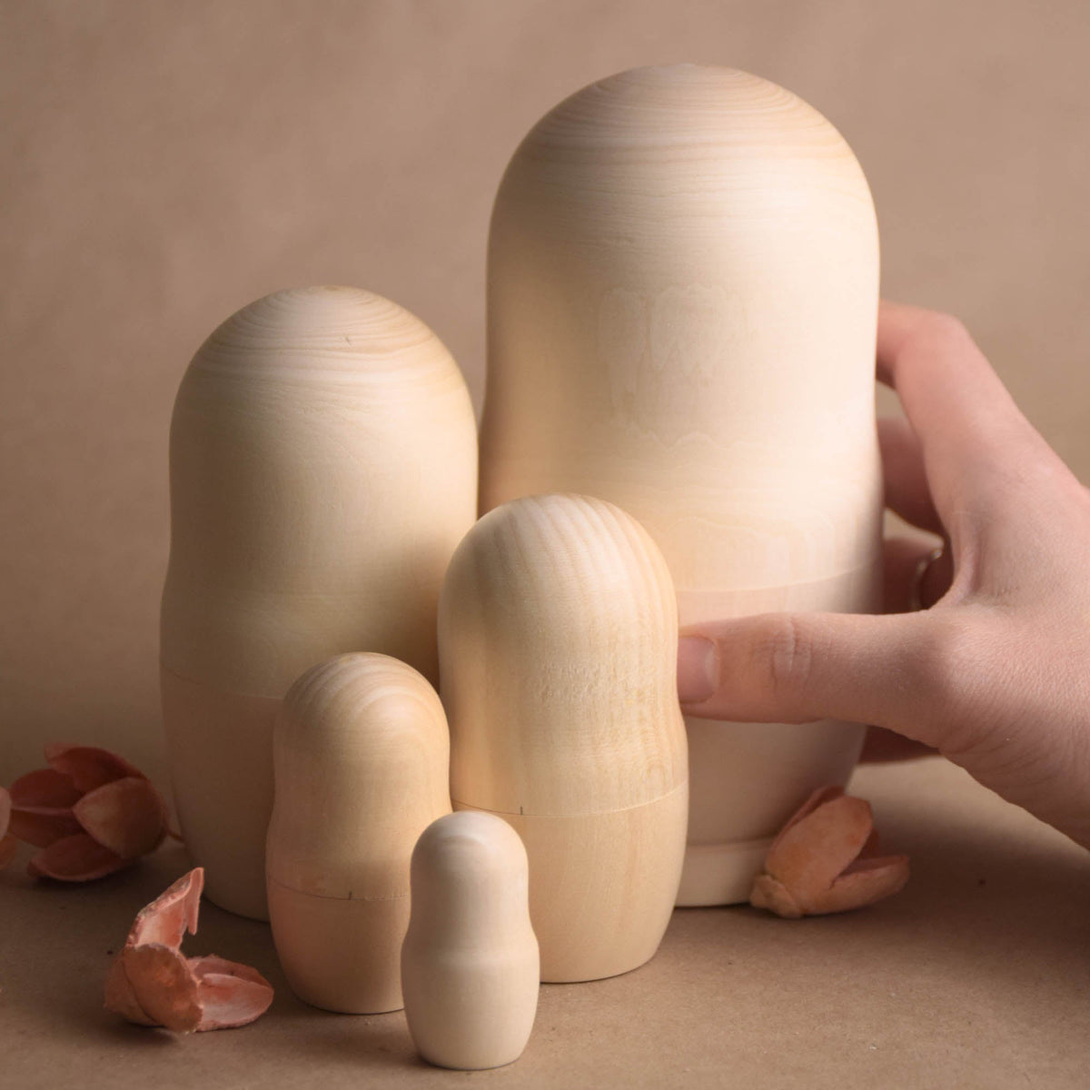 Unpainted wooden dolls with a traditional nesting design