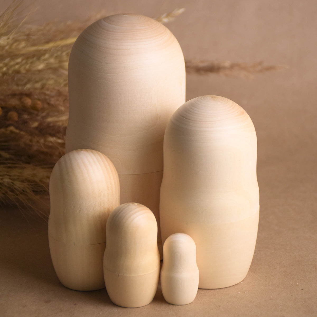 Unpainted wooden matryoshka nesting dolls