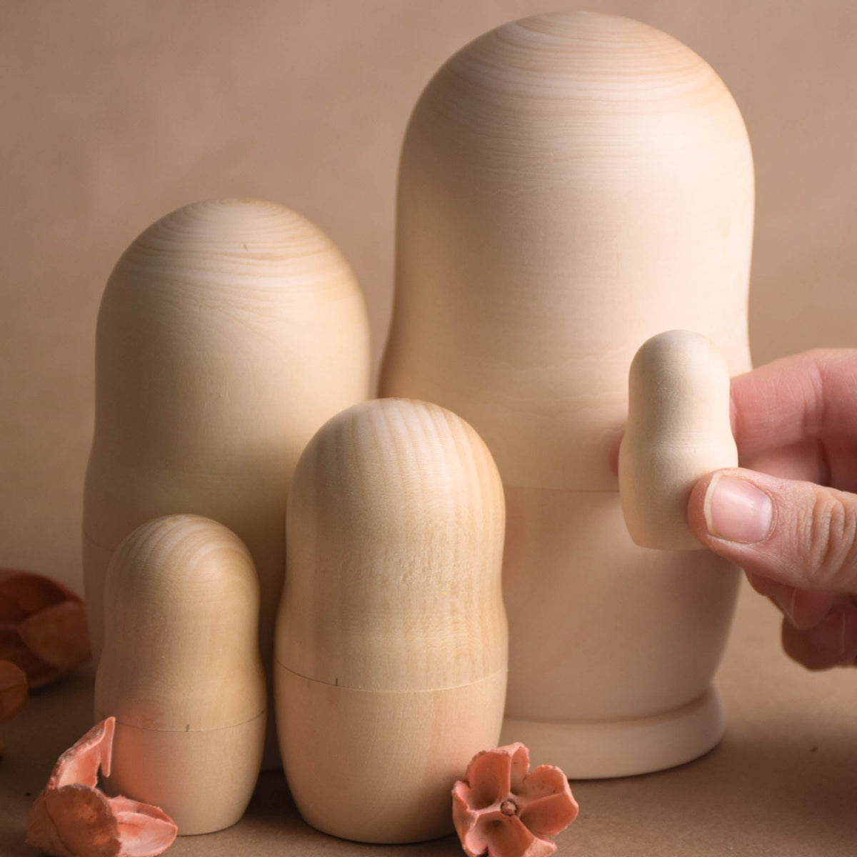 Natural wooden nesting dolls with blank surfaces