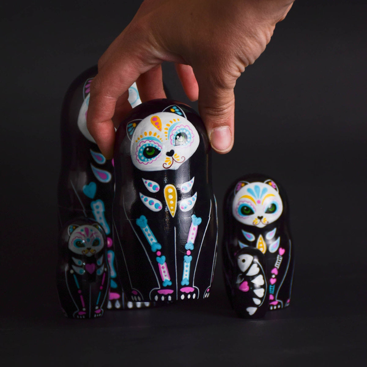Colorful wooden cat figures with a nesting design