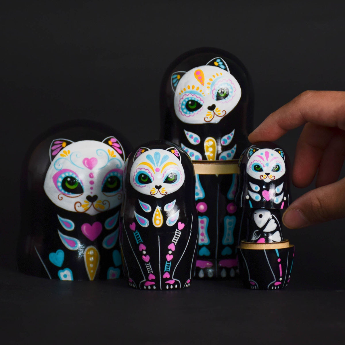 Wooden cat matryoshka dolls with intricate painted decoration