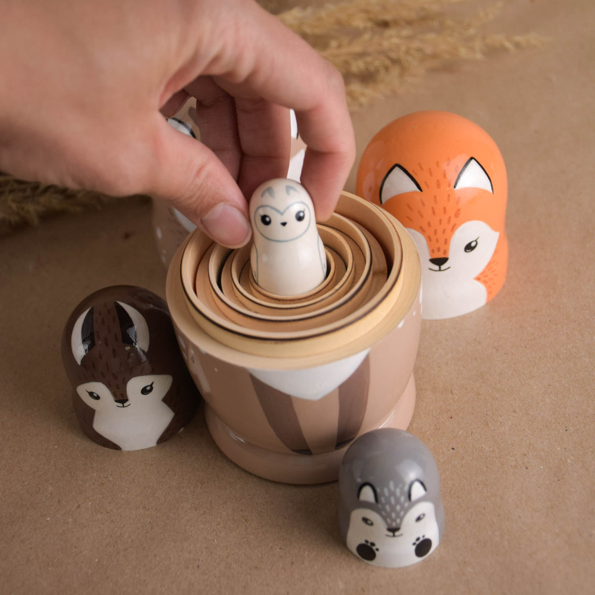 Neutral-colored wooden animal nesting figures