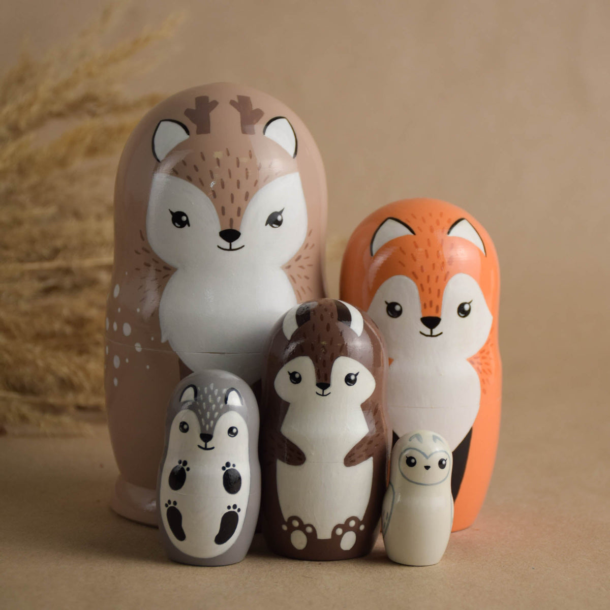 Wooden forest animal nesting dolls in neutral colors