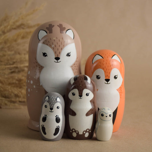Wooden forest animal nesting dolls in neutral colors