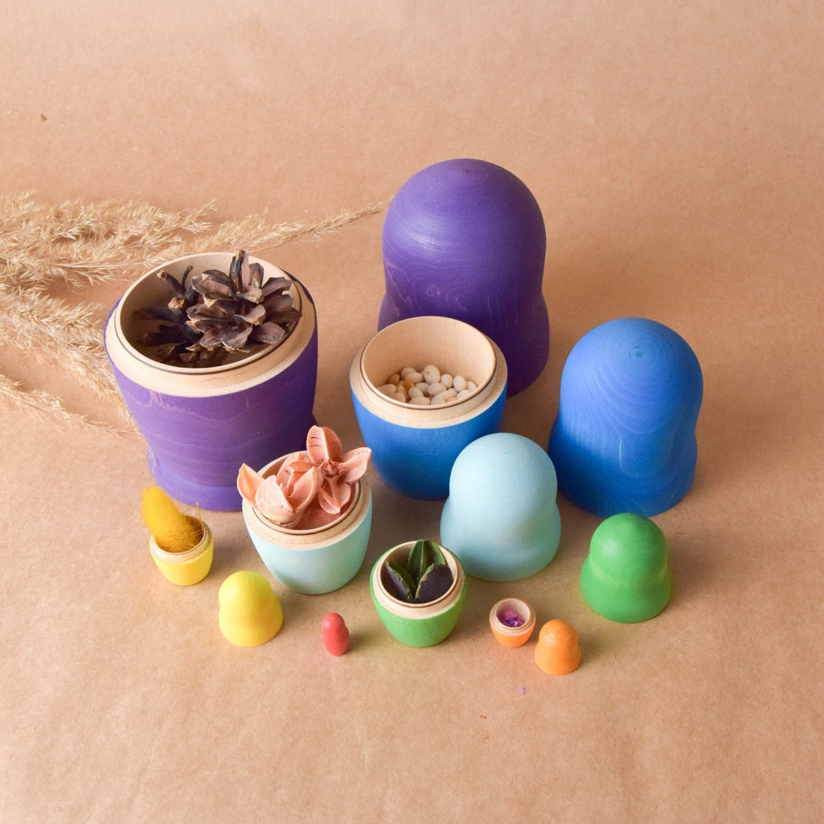 Rainbow-colored wooden dolls with a nesting design