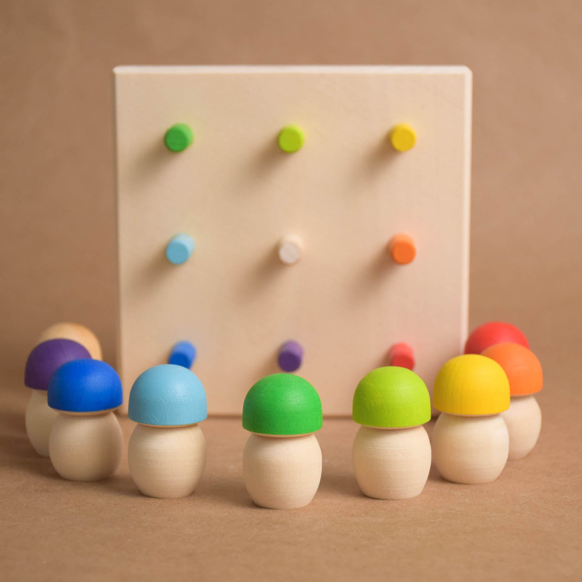 Colorful wooden mushrooms for sorting on a geoboard