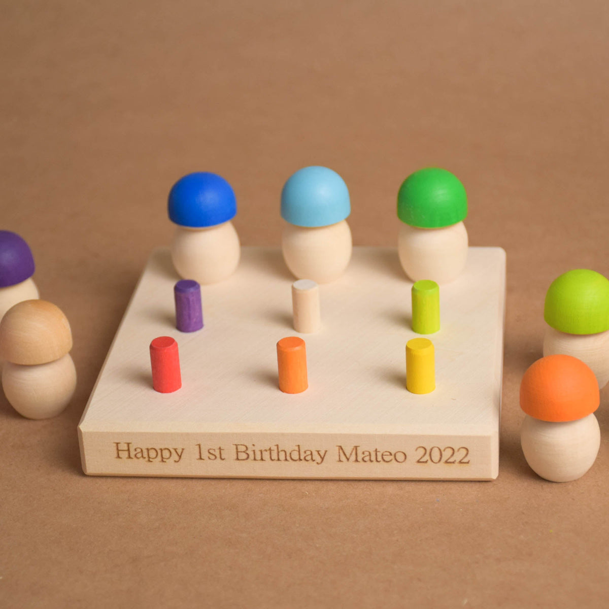 Wooden geoboard and colorful mushroom pieces
