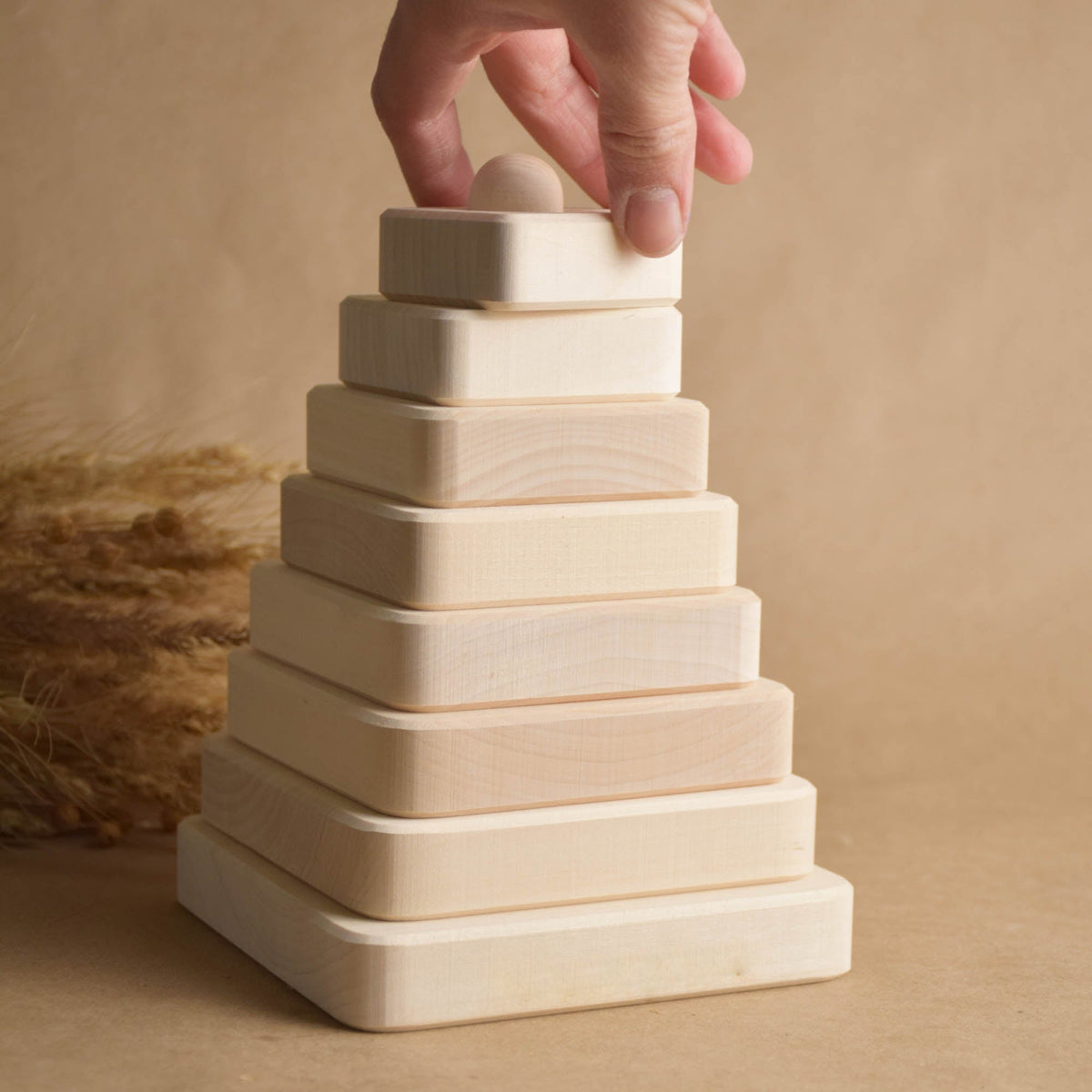 Natural wood stacking toy with square rings