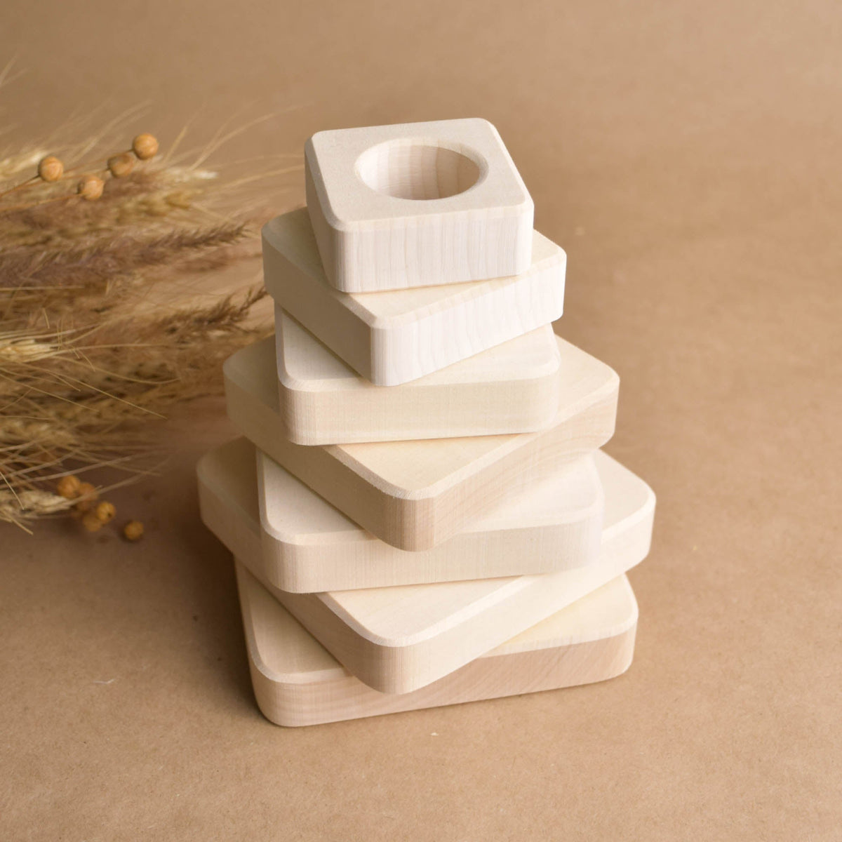 Stacking toy with square rings made from natural wood