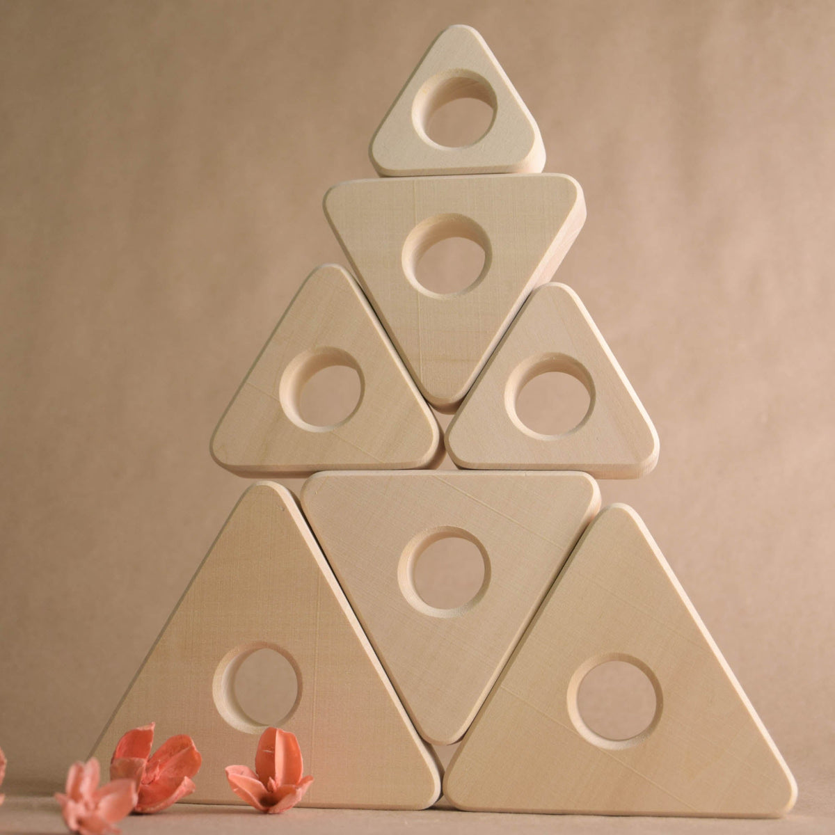 Ring stacking toy made from natural wood, with triangular rings