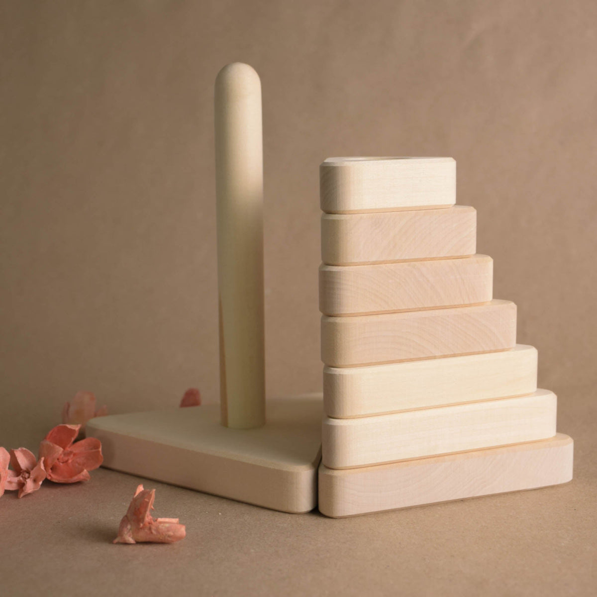 Stacking toy with triangular rings made from natural wood
