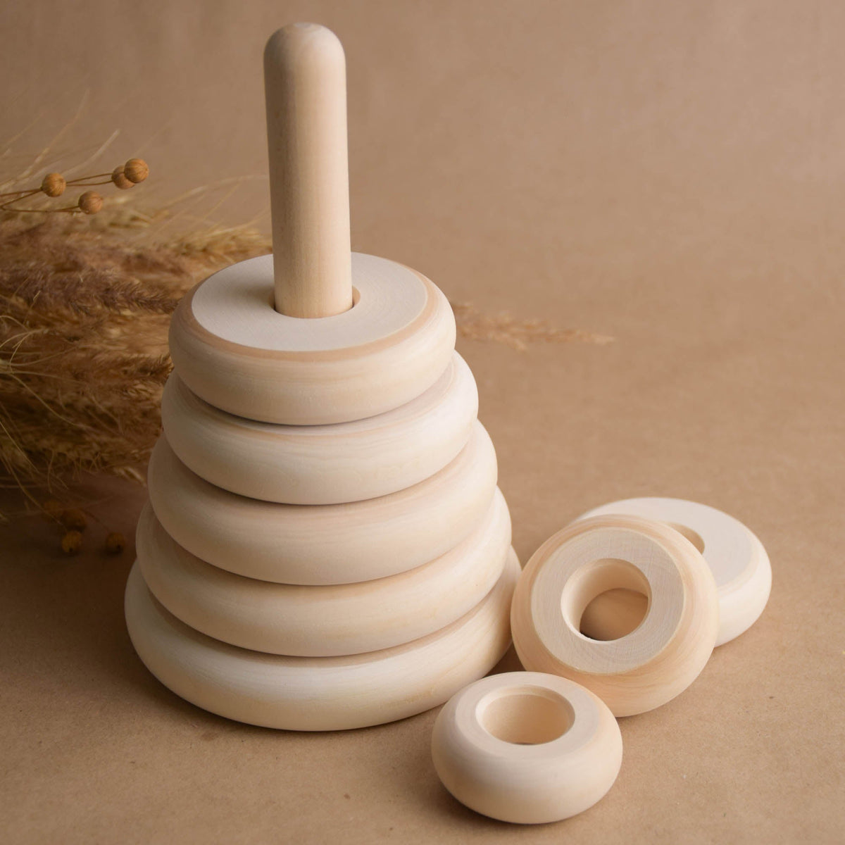 Stacking toy with turned rings made from natural wood