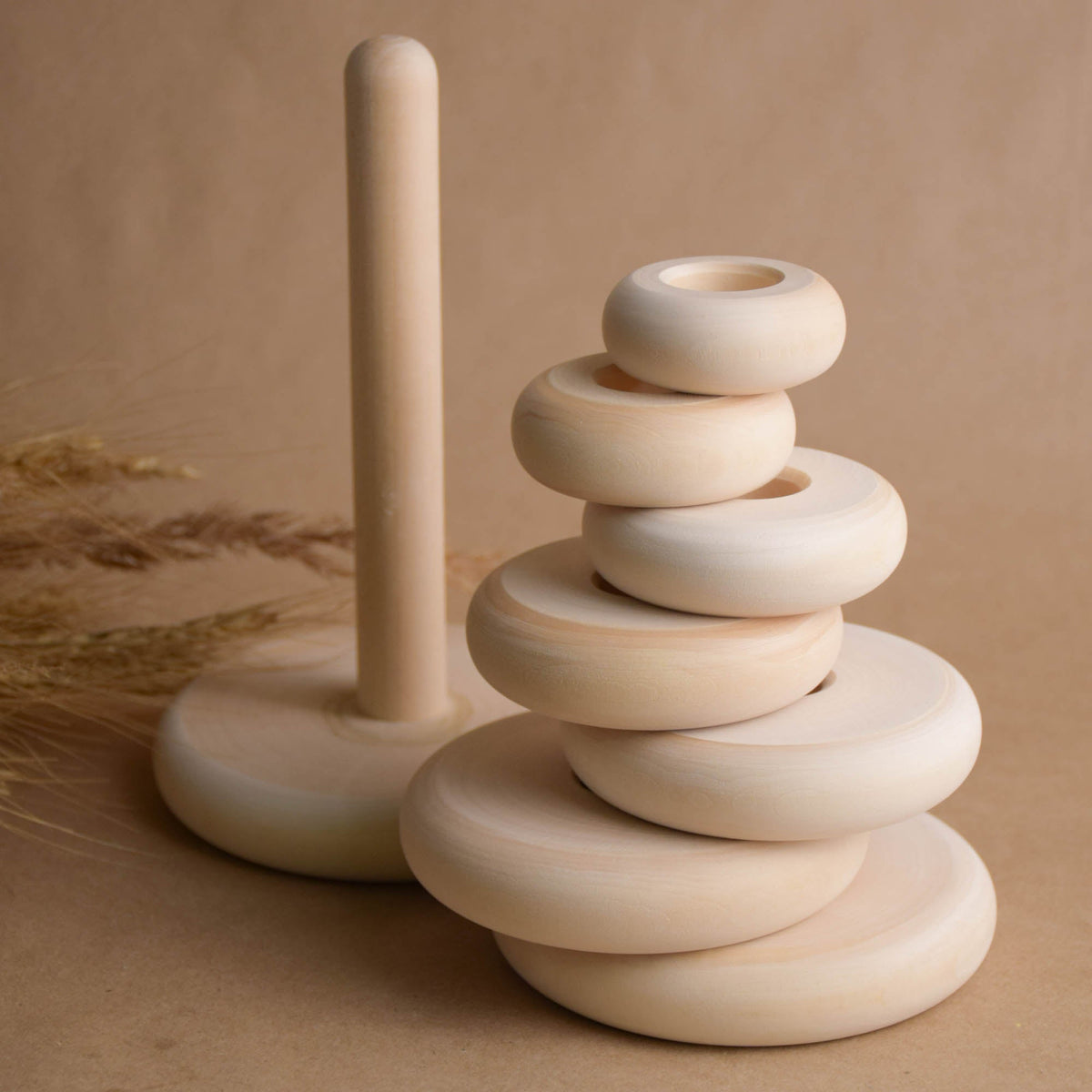 Ring stacking toy made from natural wood, with turned rings