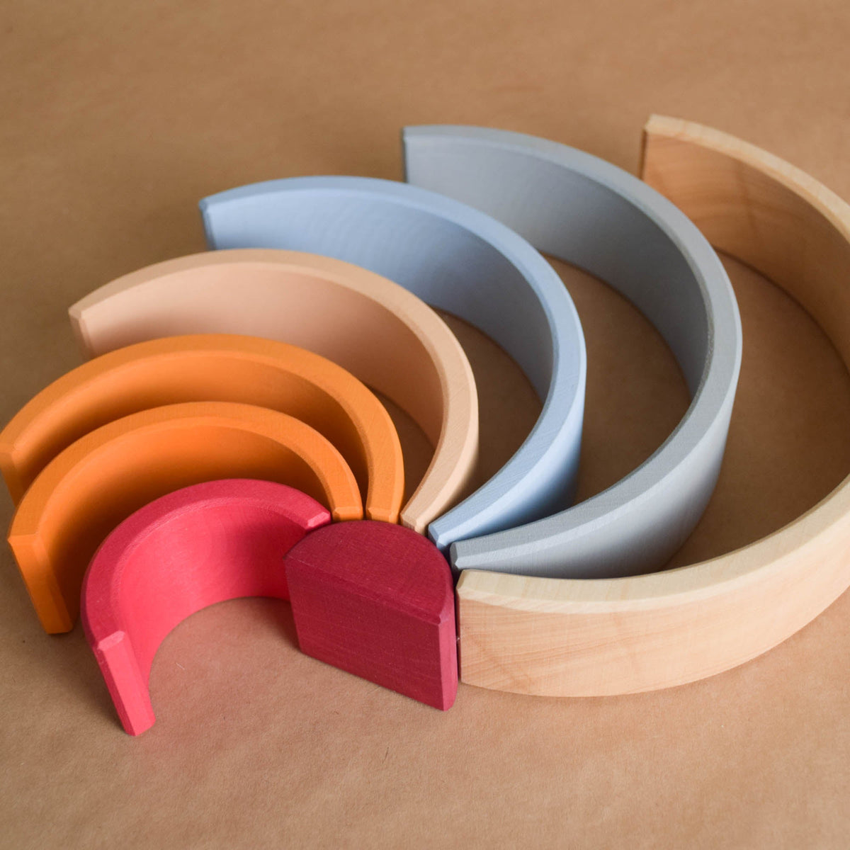 Handmade Montessori neutral rainbow stacker in linden wood with a natural wax-and-oil finish