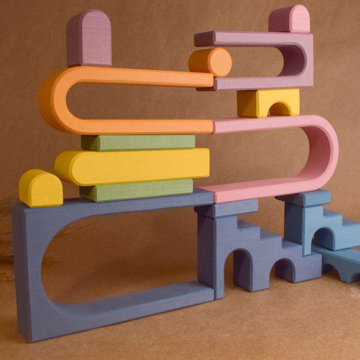 Wooden wooden rainbow stacker from the Pastel City Building Set collection, shown in a product view.