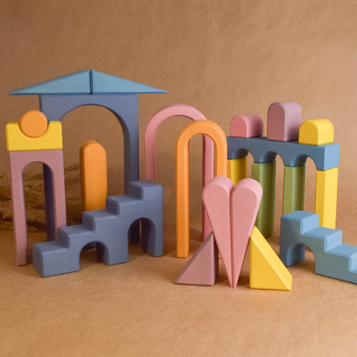 Close product view of the Pastel City Building Set wooden rainbow stacker, made from natural solid wood.