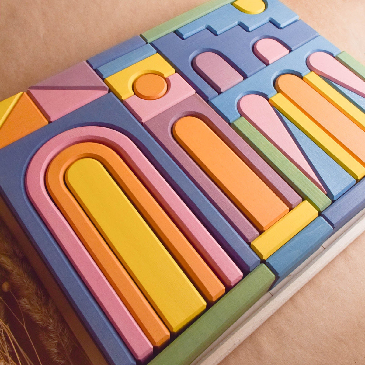 Product photo of Pastel City Building Set, a pastel-colored city-building wooden wooden rainbow stacker set.