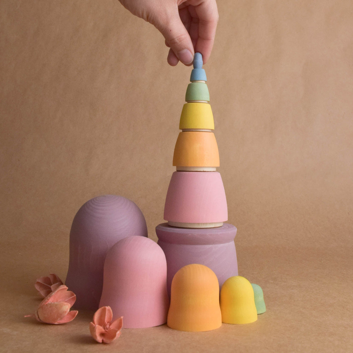 Wooden nesting dolls in graduated sizes and pastel colors