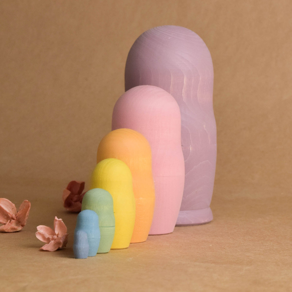 Wooden matryoshka figures with a soft pastel palette