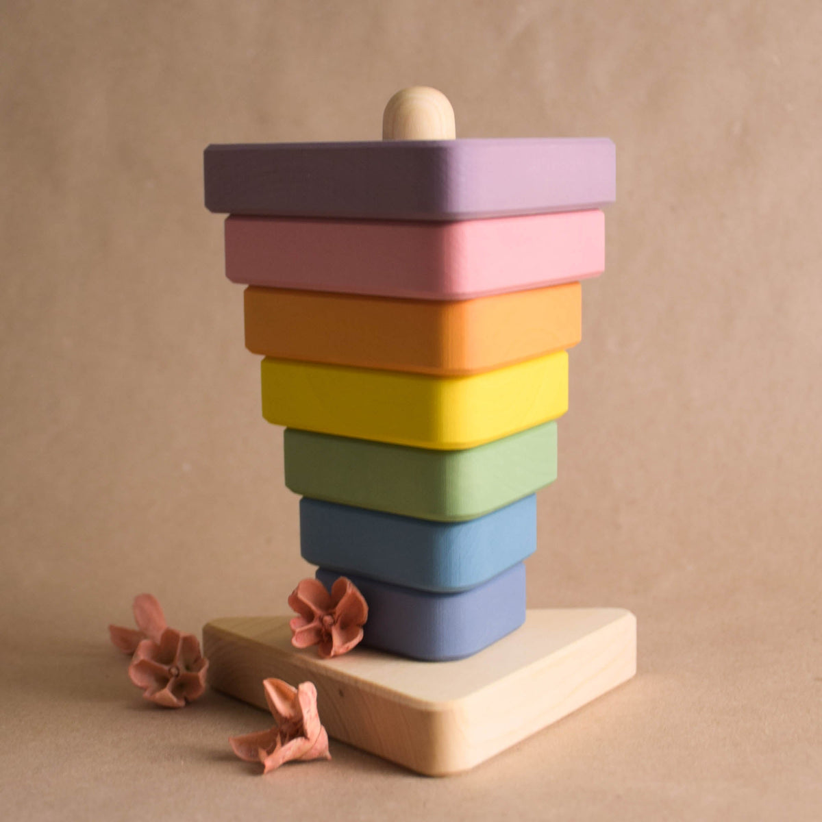 Wooden stacking toy with pastel-colored triangular rings