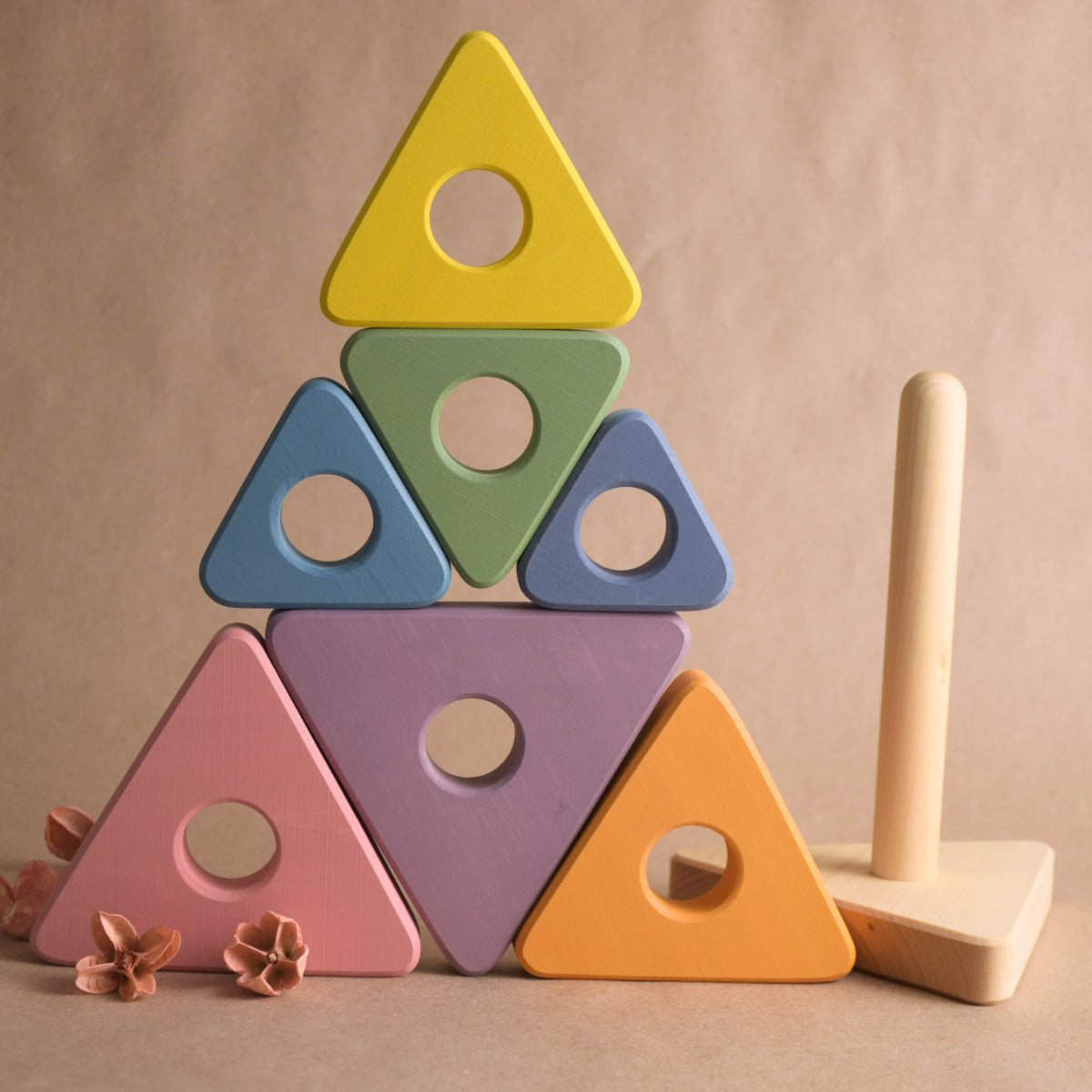 Wooden stacking rings toy with pastel-colored triangular rings