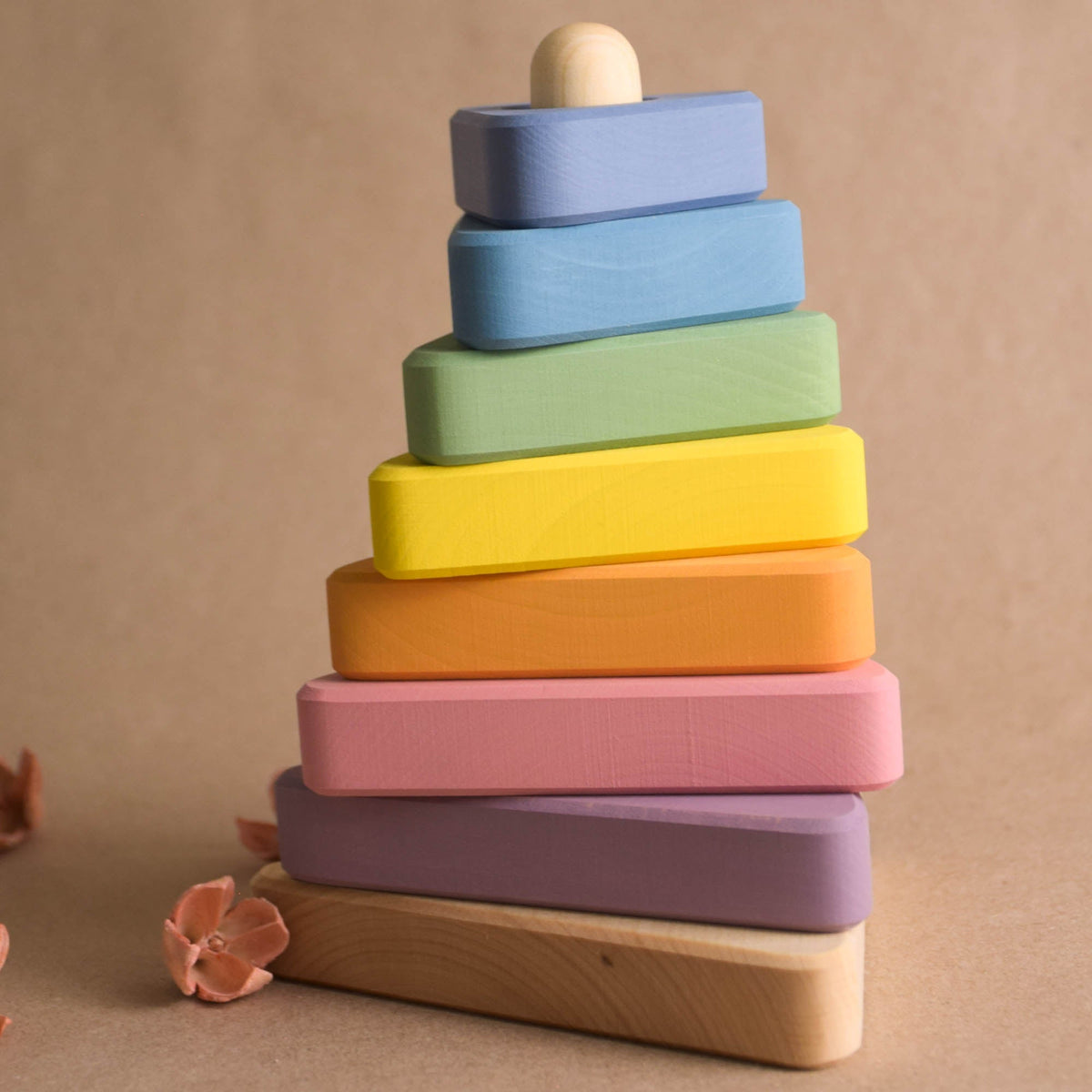 Wooden stacking toy with pastel-colored triangular rings