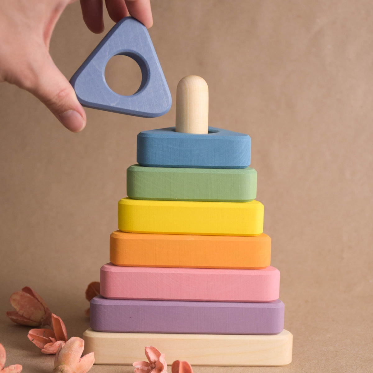 Wooden ring stacker with pastel-colored triangular rings