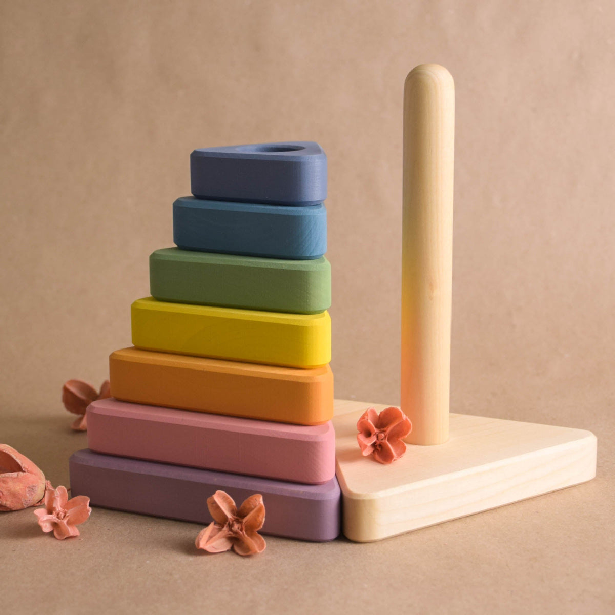 Ring stacking toy made from wood, with pastel-colored triangular rings
