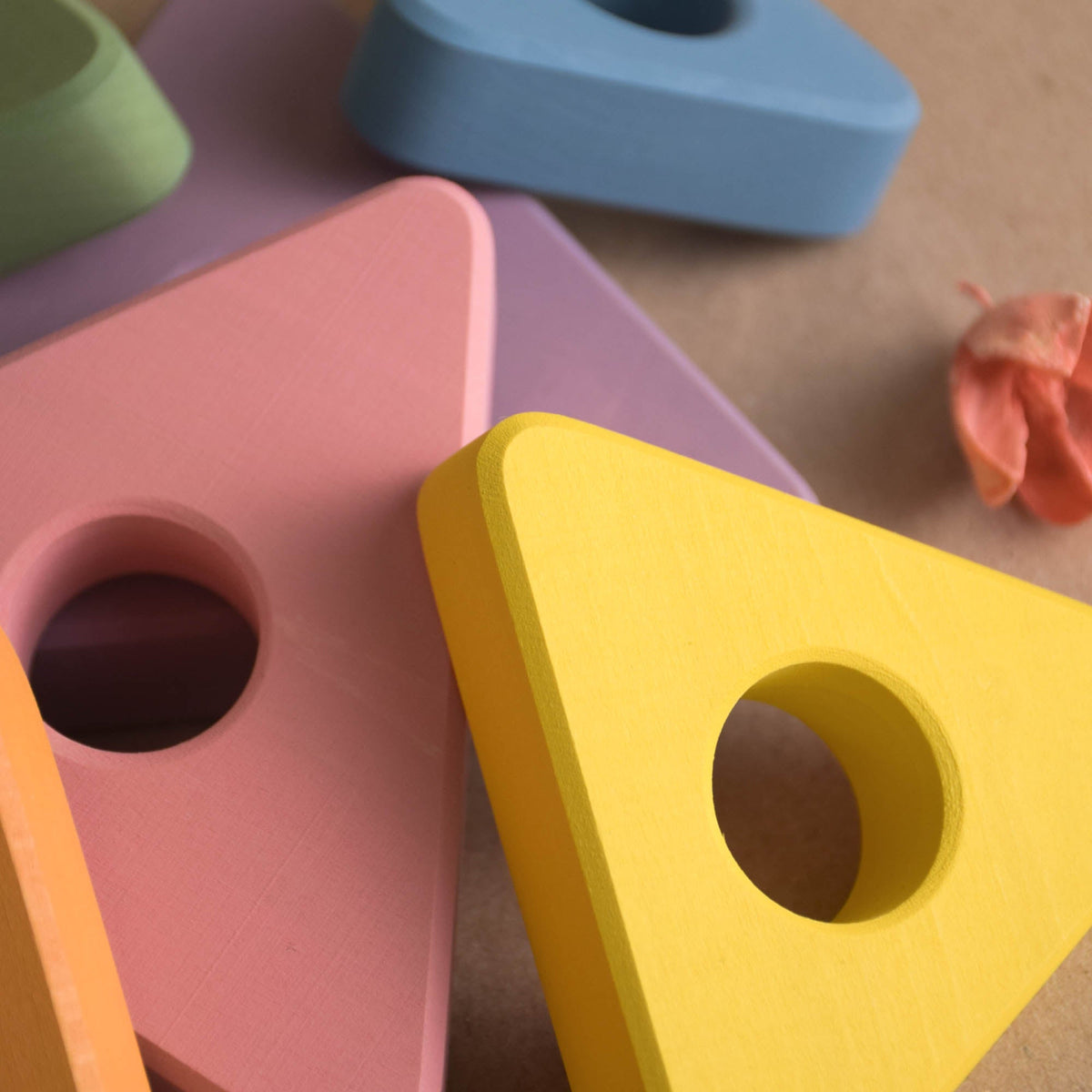 Wooden ring stacker with pastel-colored triangular rings