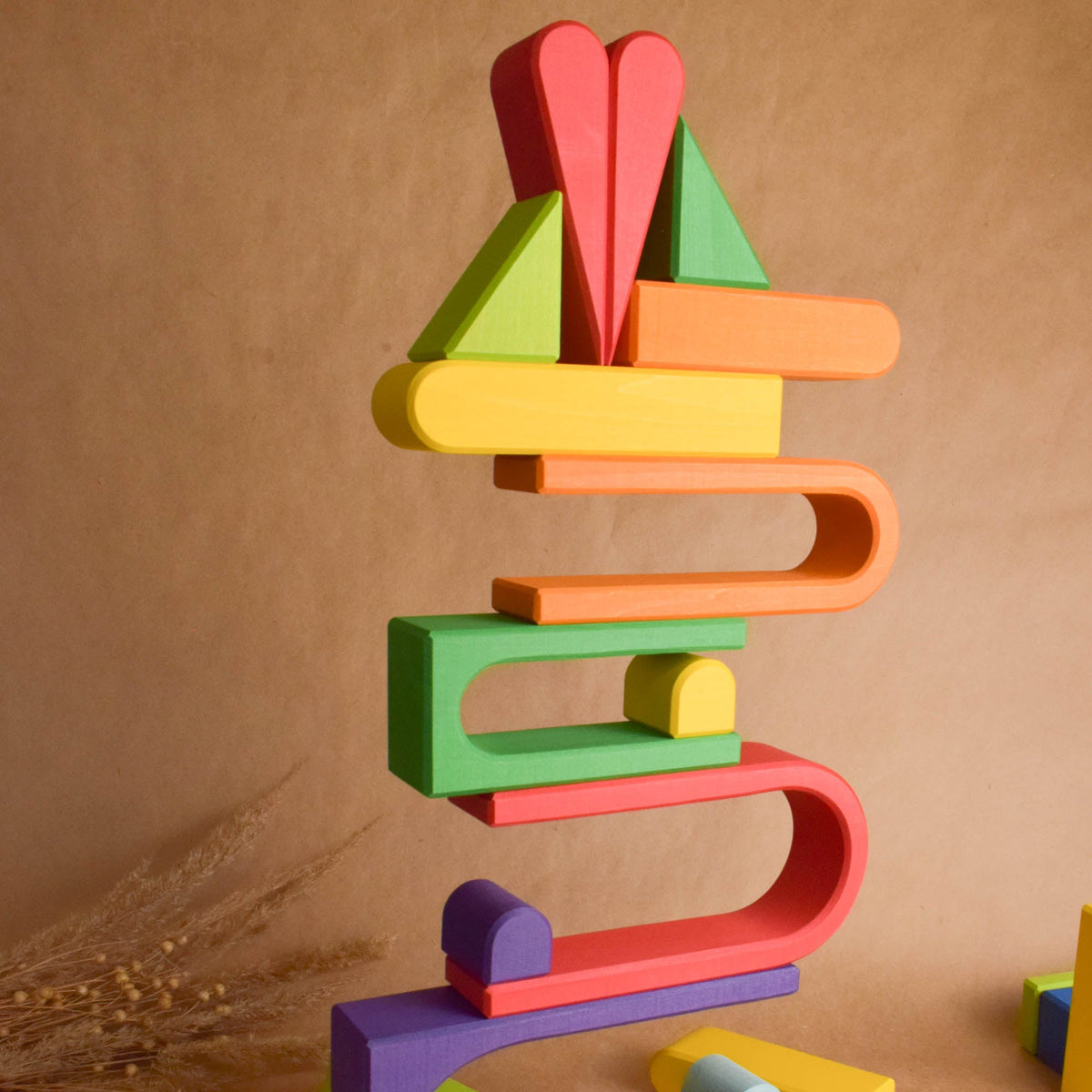 Close product view of the Rainbow City Building Set wooden rainbow stacker, finished with natural colored wax.