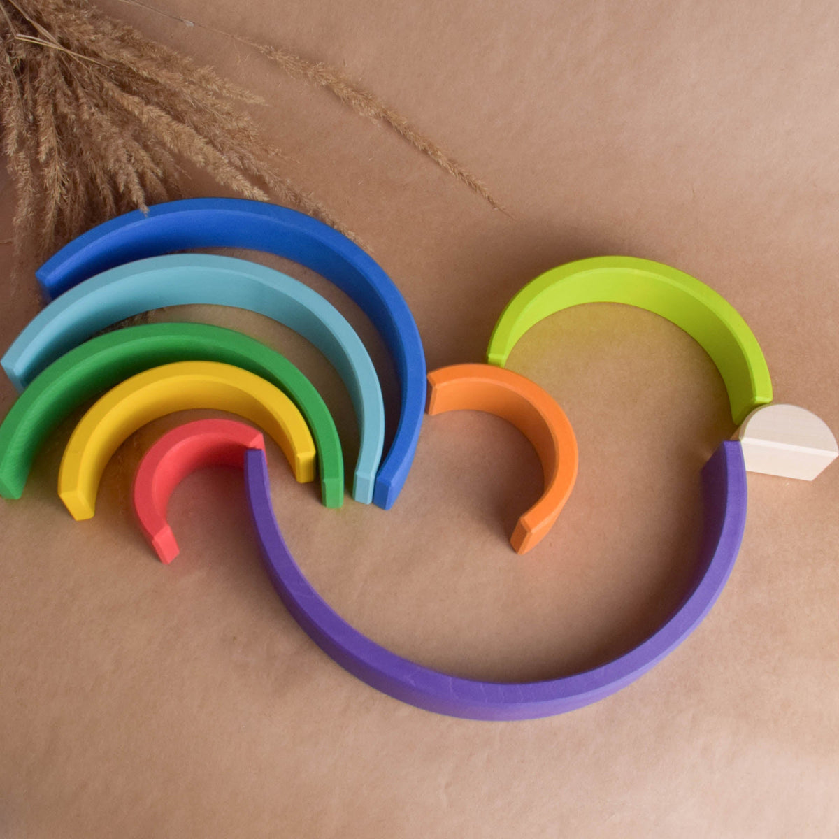 Handmade Montessori large rainbow stacking toy in linden wood with a natural wax-and-oil finish