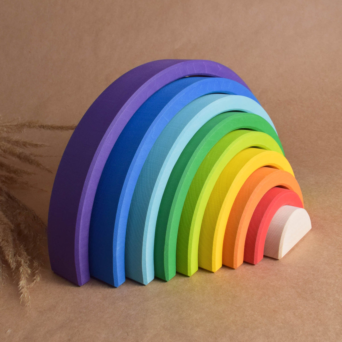 Handmade Montessori large rainbow stacking toy in linden wood with a natural wax-and-oil finish