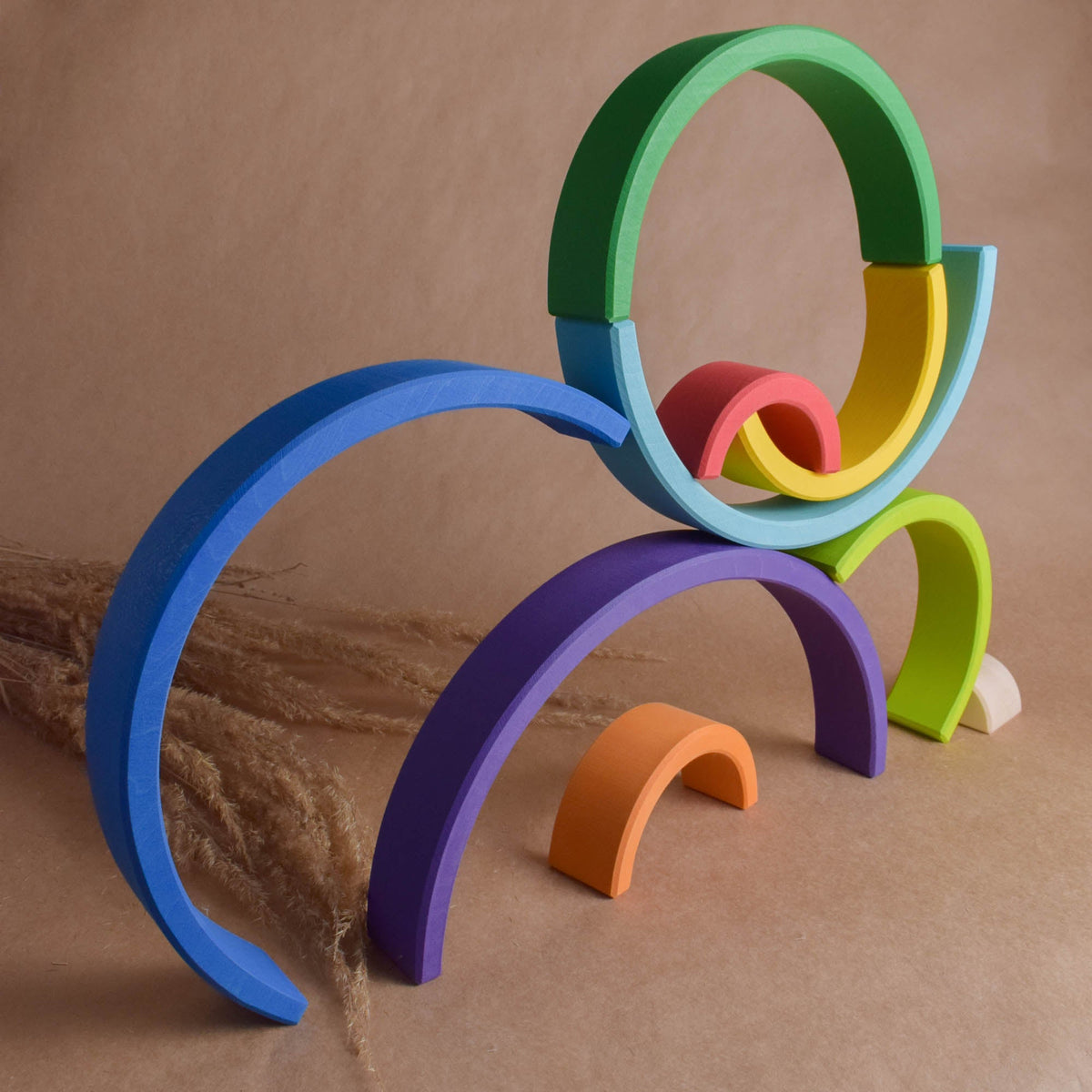 Handmade Montessori large rainbow stacking toy in linden wood with a natural wax-and-oil finish