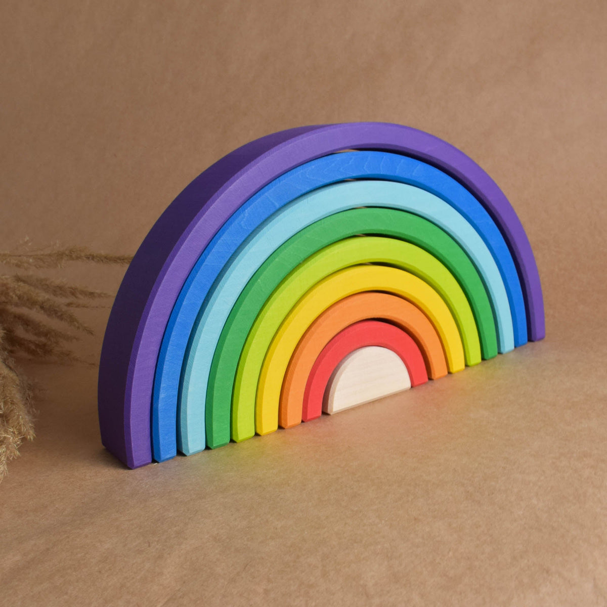 Handmade Montessori large rainbow stacking toy in linden wood with a natural wax-and-oil finish