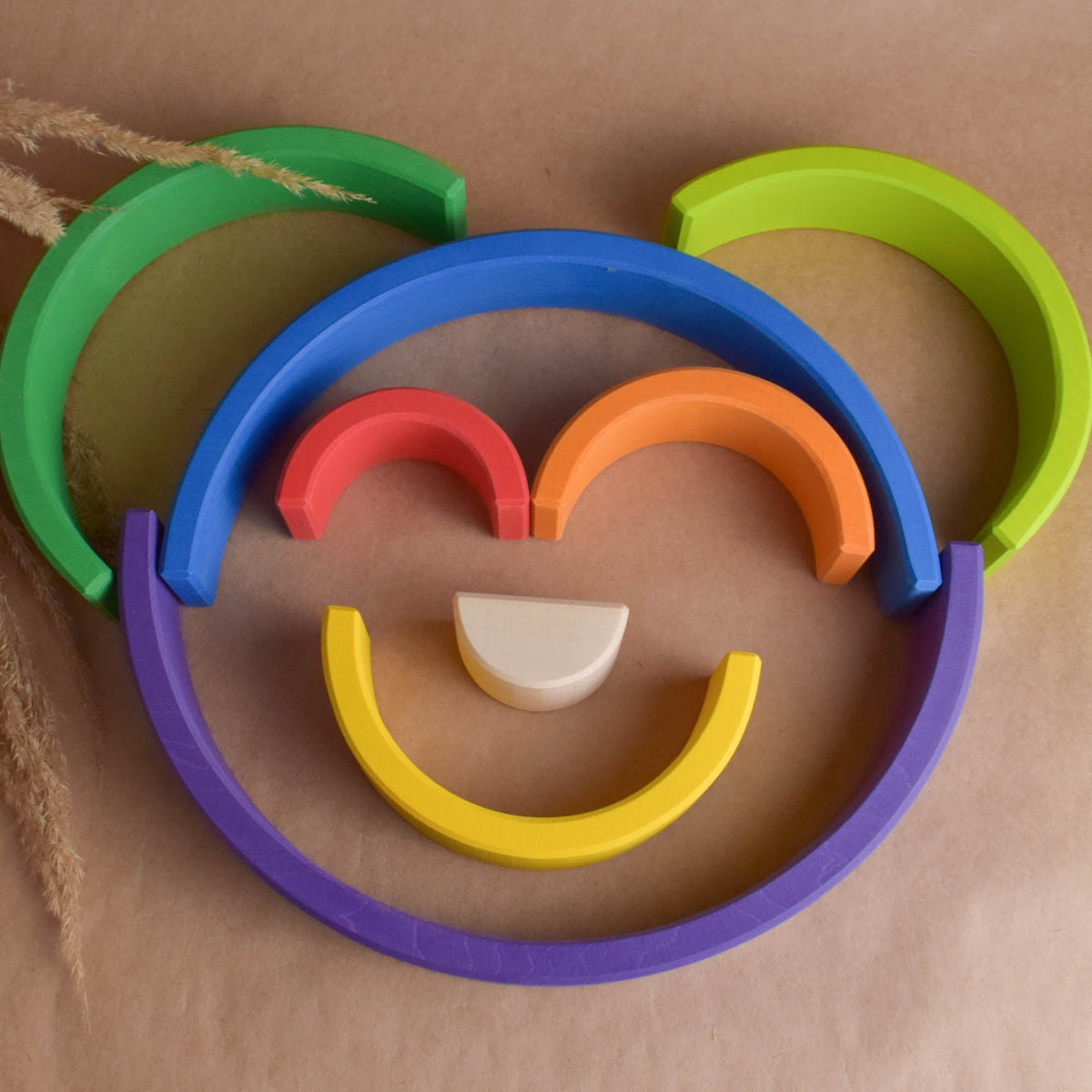 Handmade Montessori large rainbow stacking toy in linden wood with a natural wax-and-oil finish