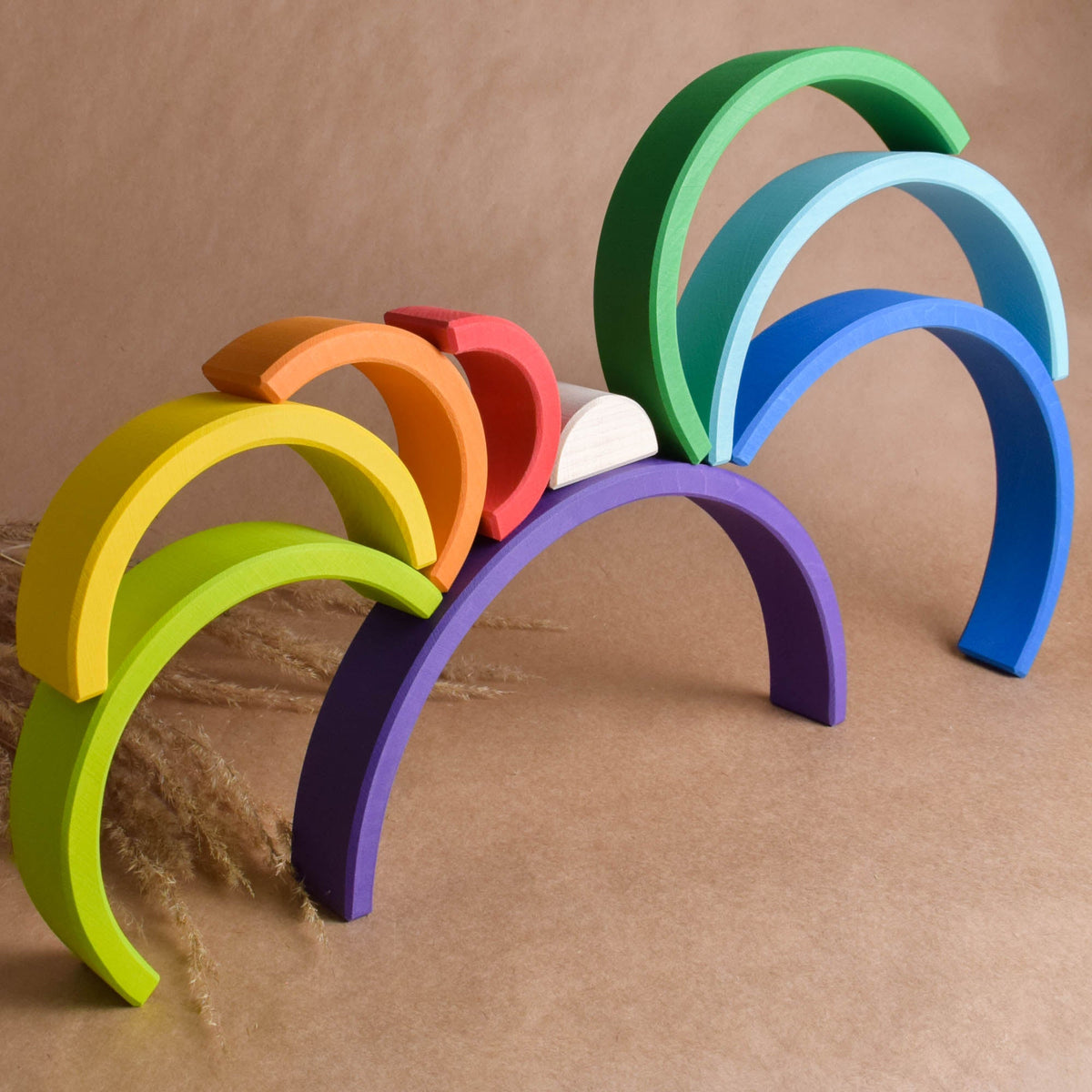 Handmade Montessori large rainbow stacking toy in linden wood with a natural wax-and-oil finish