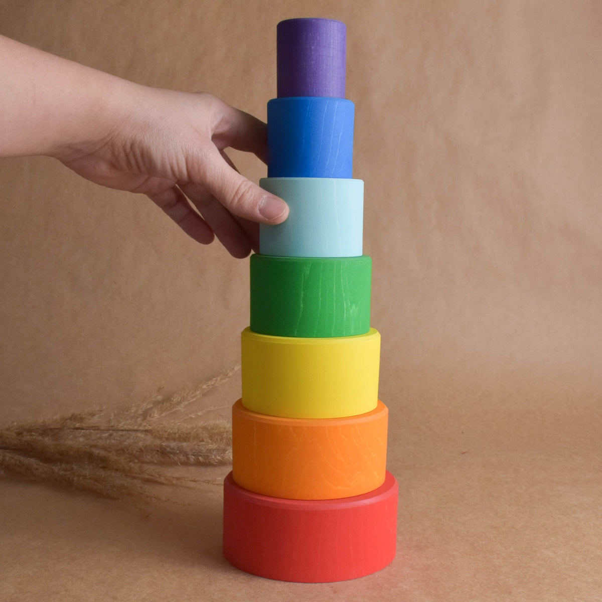 Rainbow-colored wooden stacking cups