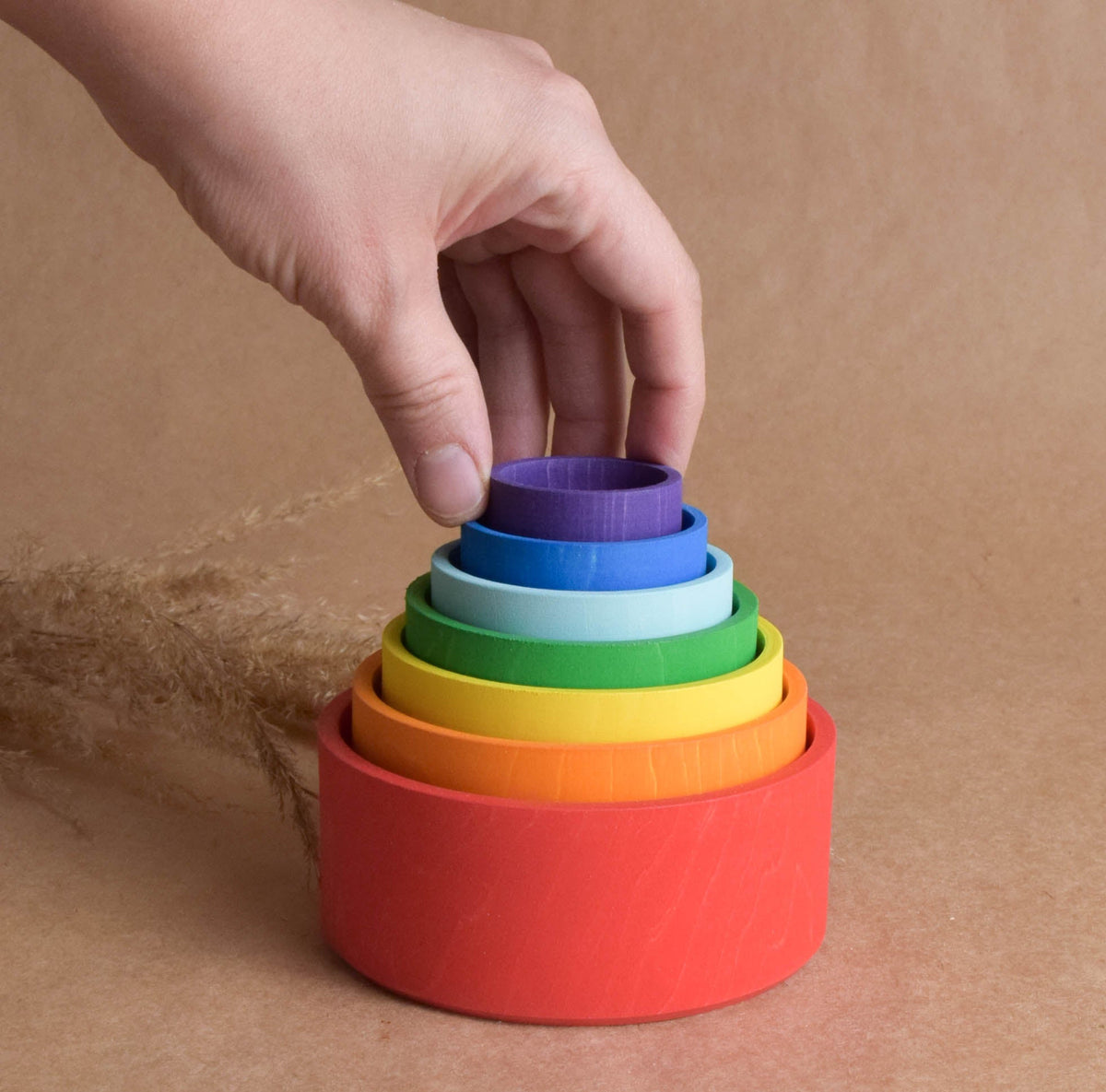 Rainbow-colored wooden stacking cups