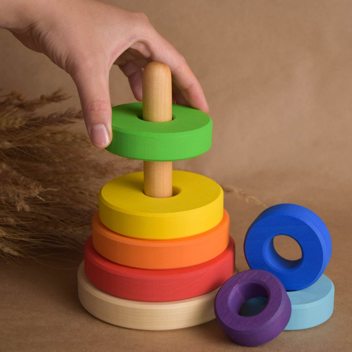 Stacking toy with rainbow-colored rings made from wood