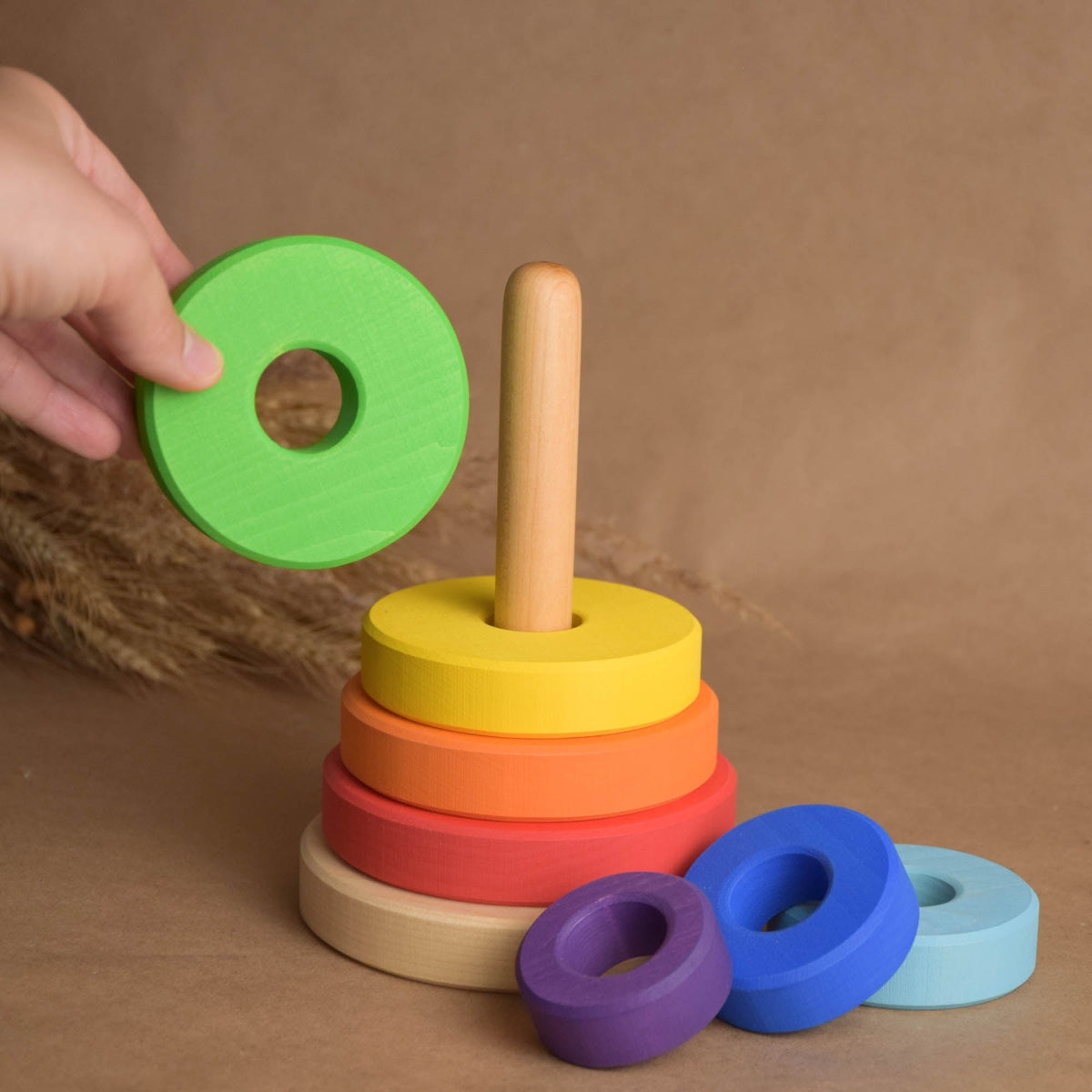 Wooden stacking rings toy with rainbow-colored rings