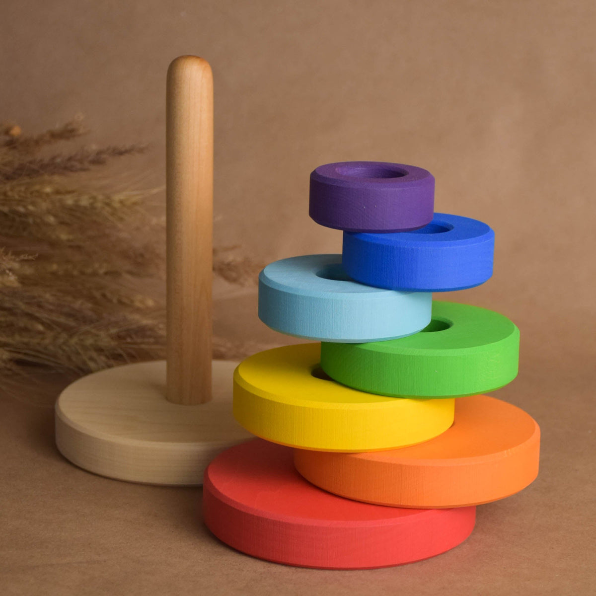Wooden ring stacker with rainbow-colored rings
